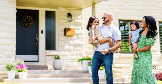 Happy family with front door in the background