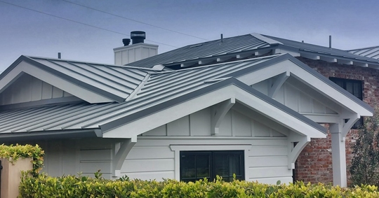 house with gray standing seam metal roof