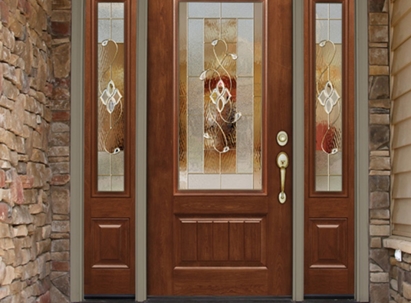A brown front door with a decorative glass window, flanked by matching narrow side panels.