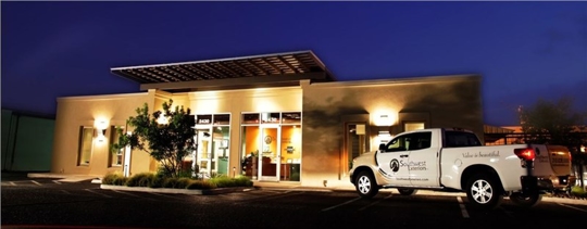 A nighttime photo of Southwest Exteriors' office building and a branded truck.