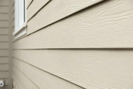 This close-up shows tan siding with a wood-grain texture, visible in a Media Manager window.