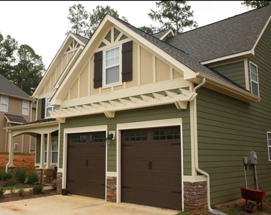 A suburban house with an attached two-car garage and multi-colored siding.