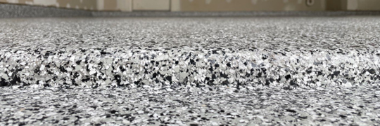 This image shows a close up of a floor with a speckled, multi-toned surface.