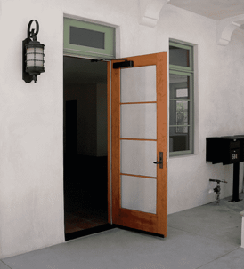 Exterior doorway with a paneled wood door and a black light fixture.