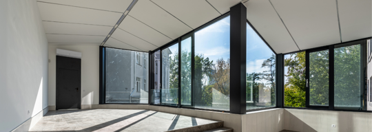 large windows and a black door