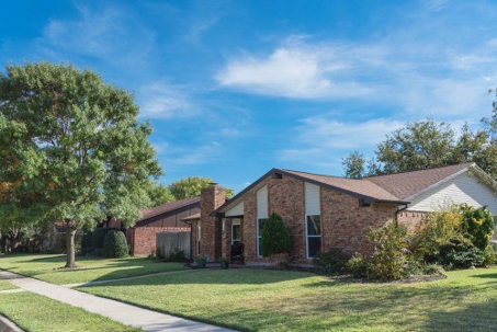a brick single-family house with a blue sky