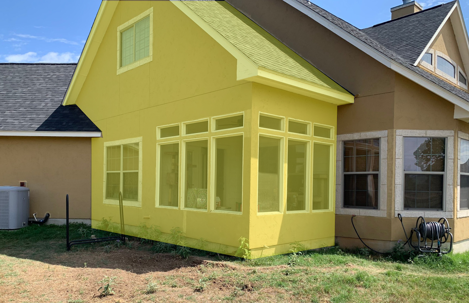 A sunroom addition on a house, highlighted in yellow.
