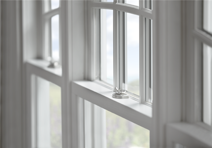 A close-up showcases a set of white, multi-pane windows, some with a chrome latch