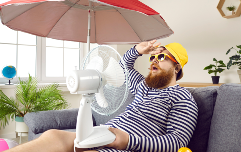 a man holding a fan and an umbrella