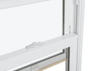 A close up of a white window with a white latch on the sash.