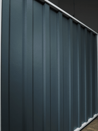 Vertical board and batten siding in a smooth finish in navy color.