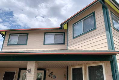 A picture of a house with the trim and underside of the roof is highlighted red and yellow to represent the soffit and the fascia.