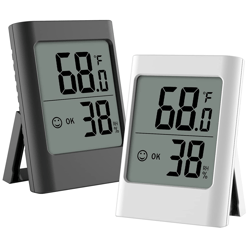 Two digital thermometers, one gray and one white, that read temperature and humidity levels. 