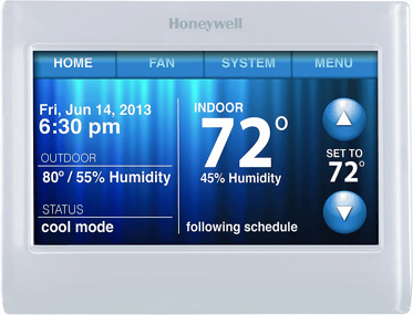 A Honeywell smart thermostat that reads temperature, humidity levels, date, time, and more. It is white with a blue screen. 