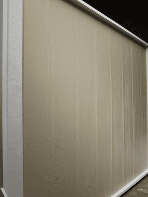 Vertical board and batten siding in a cedar finish in a beige color.