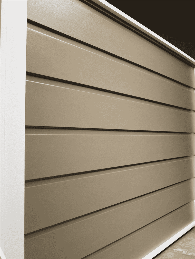 A wall of dutch smooth horizontal siding in a dark beige color. 