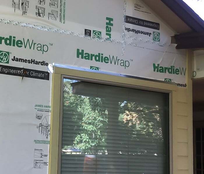 Z-flashing The side of a house with the siding exposed under construction and one single window. There is a sil…