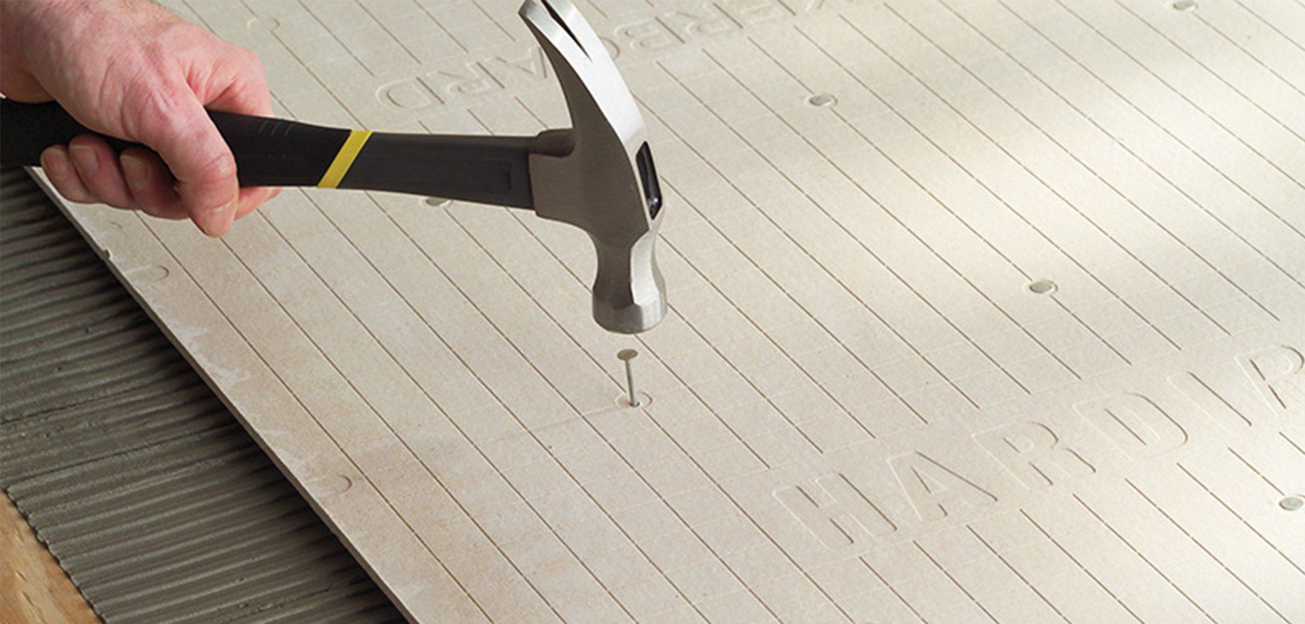 a man hammering the nail